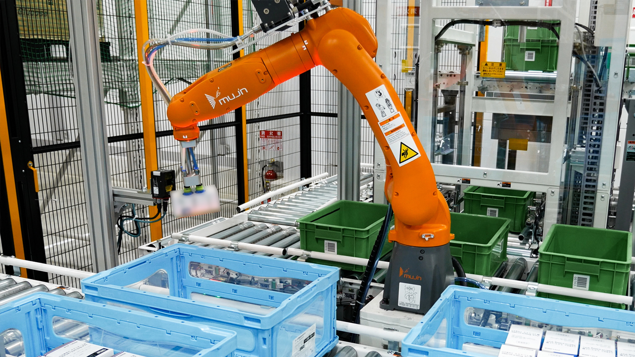 Orange piece picking robot picking up a package